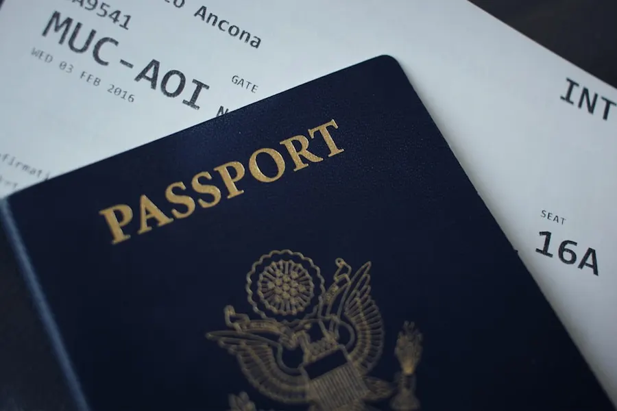 Ilustrasi mimpi ketinggalan paspor — passport booklet on top of white paper
