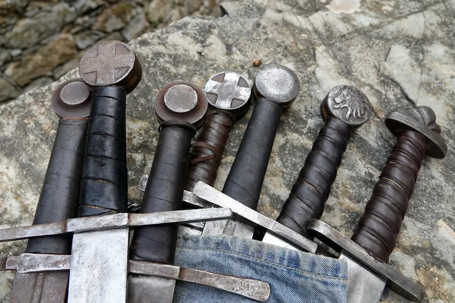 Ilustrasi mimpi pedang — a bunch of different types of tools on a rock