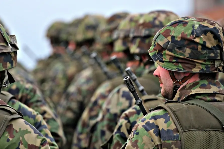 Ilustrasi mimpi tentara — man in green and brown camouflage uniform holding black rifle